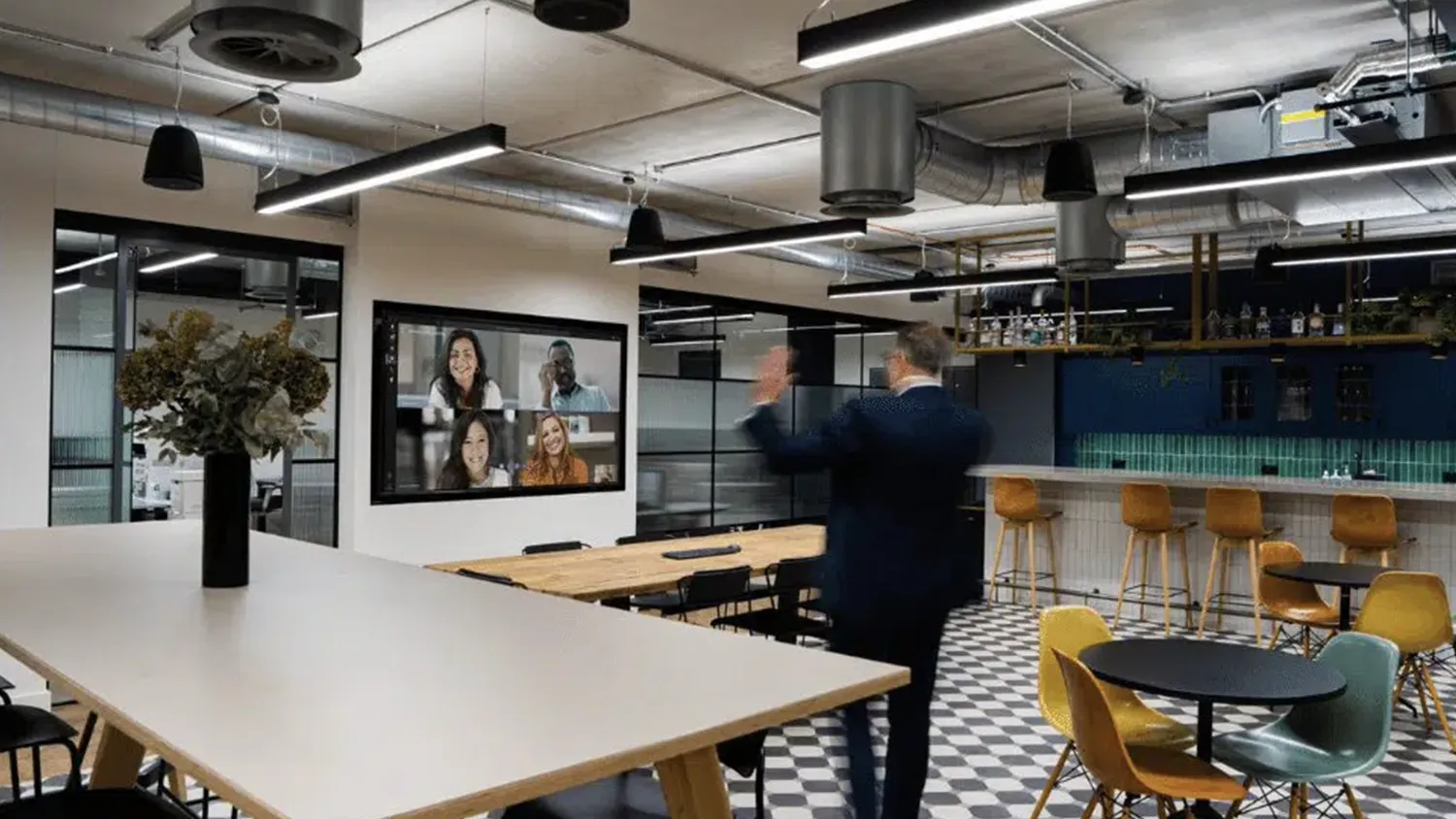 Townhall area featuring SONOS audio with video conferencing image repeated from adjacent divisible boardroom