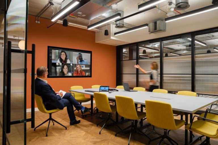 Large Teams Room in Lee & Thompson's London Office with two people